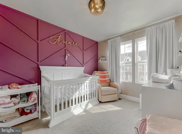 a bedroom with furniture and a large window