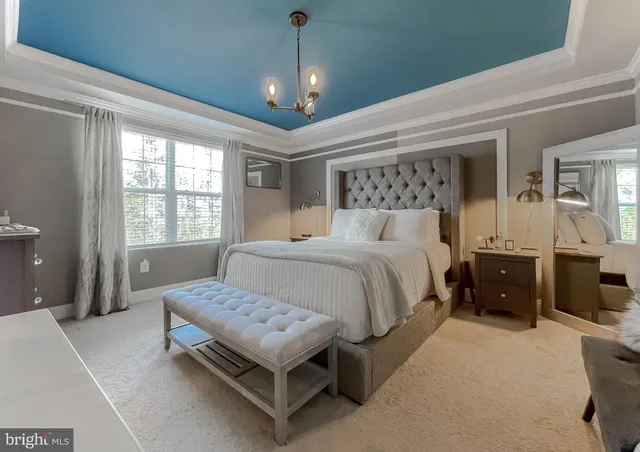 a bedroom with a bed and a chandelier