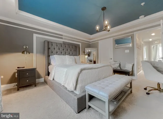 a bedroom with a bed and a chandelier