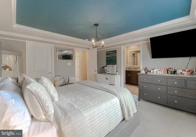 a bedroom with a bed tv and a window