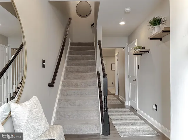 a view of entryway and hall with wooden floor