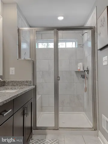 a bathroom with a shower and a sink