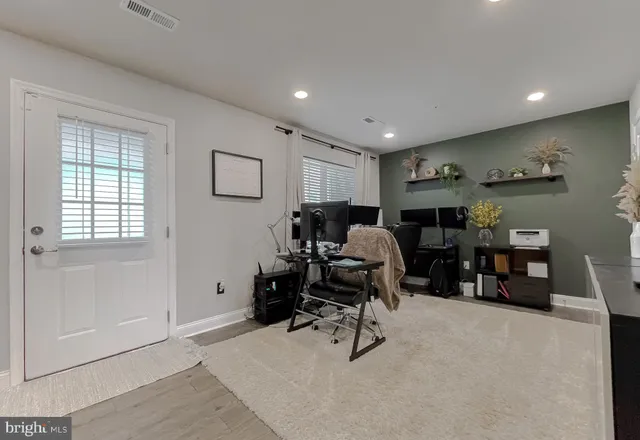 a view of a livingroom with workspace and a window