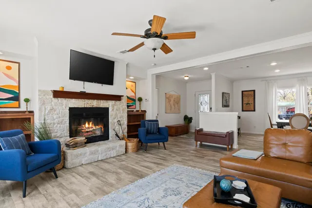 a living room with furniture and wooden floor