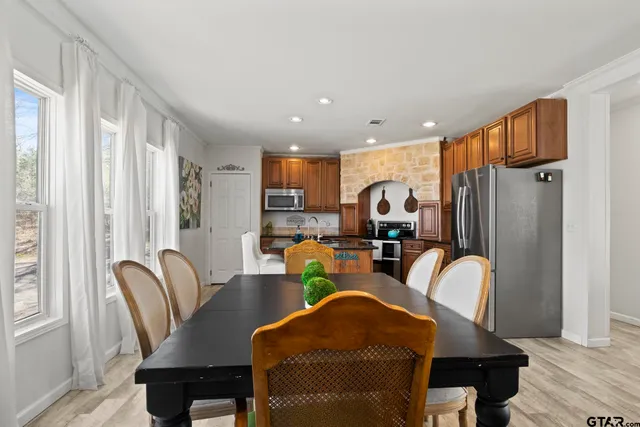 a kitchen with stainless steel appliances granite countertop a stove refrigerator sink and cabinets