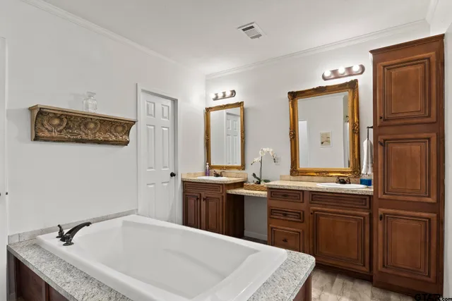 a spacious bathroom with a granite countertop sink and a mirror