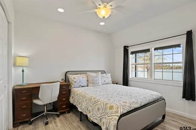 a view of a lake with couches table and chairs