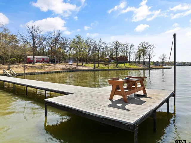 a view of a lake with couches chairs