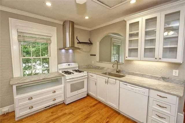 a kitchen with granite countertop a sink stainless steel appliances and cabinets