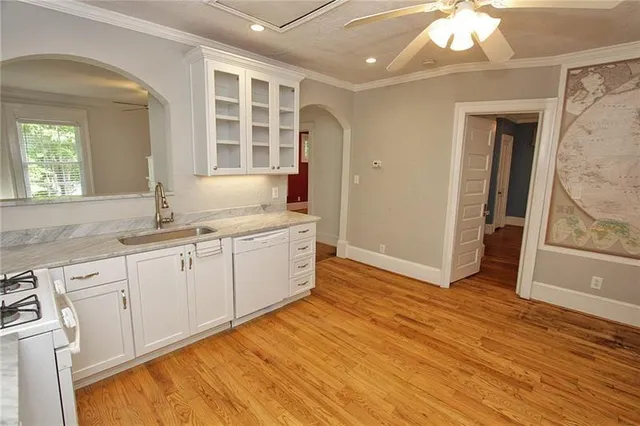 a view of a kitchen with wooden floor and a sink