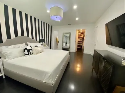 a bed sitting in a room next to a window