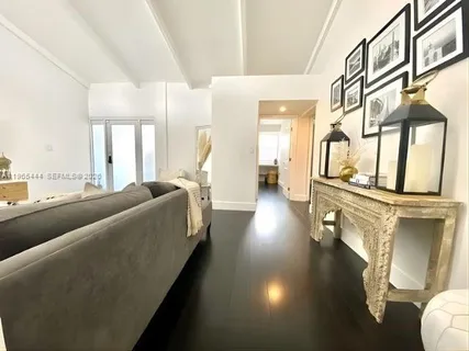 a living room with couches a fireplace with wooden floor