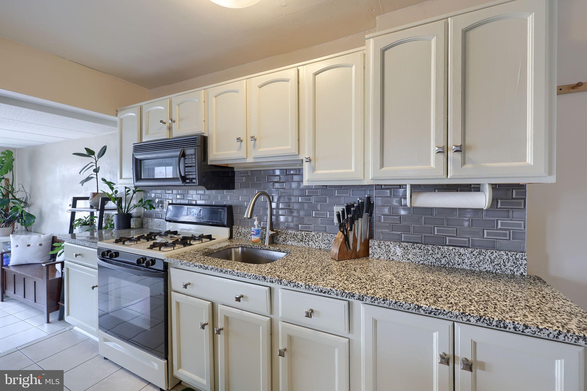 849 Delta Avenue Reading, PA 19605 - Photo 12 of 31 a kitchen with stainless steel appliances granite countertop a sink a stove and a granite counter tops