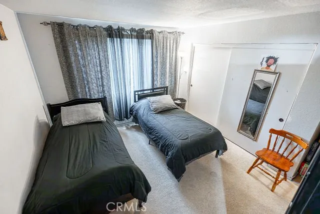 a bedroom with a bed and a mirror