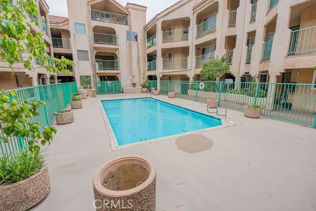 a view of a house with a swimming pool and a yard