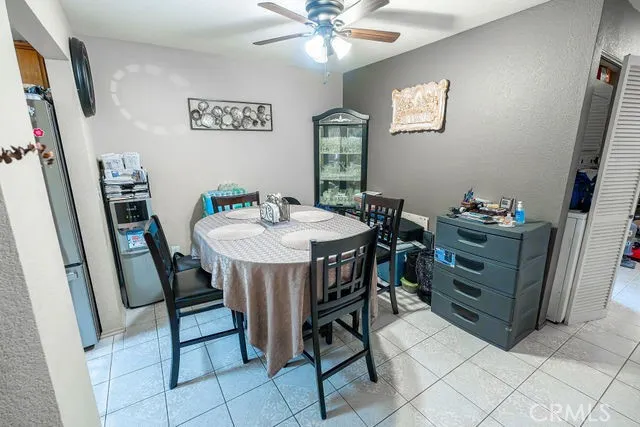 a view of a dining room with furniture and a chandelier fan