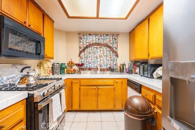 a kitchen with a stove a sink and a microwave