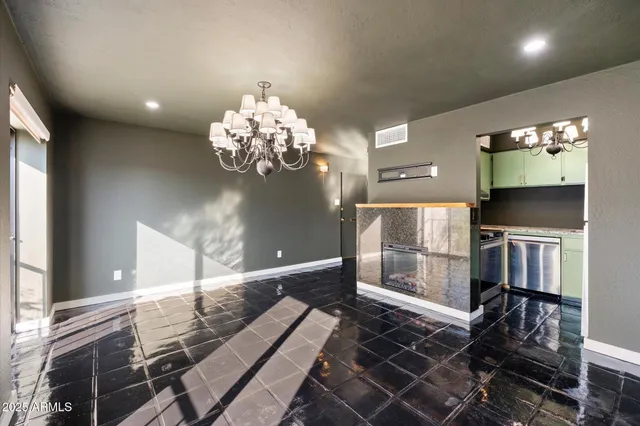 a room with stainless steel appliances granite countertop a washer and dryer