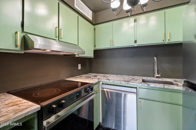 a kitchen with granite countertop a sink and cabinets