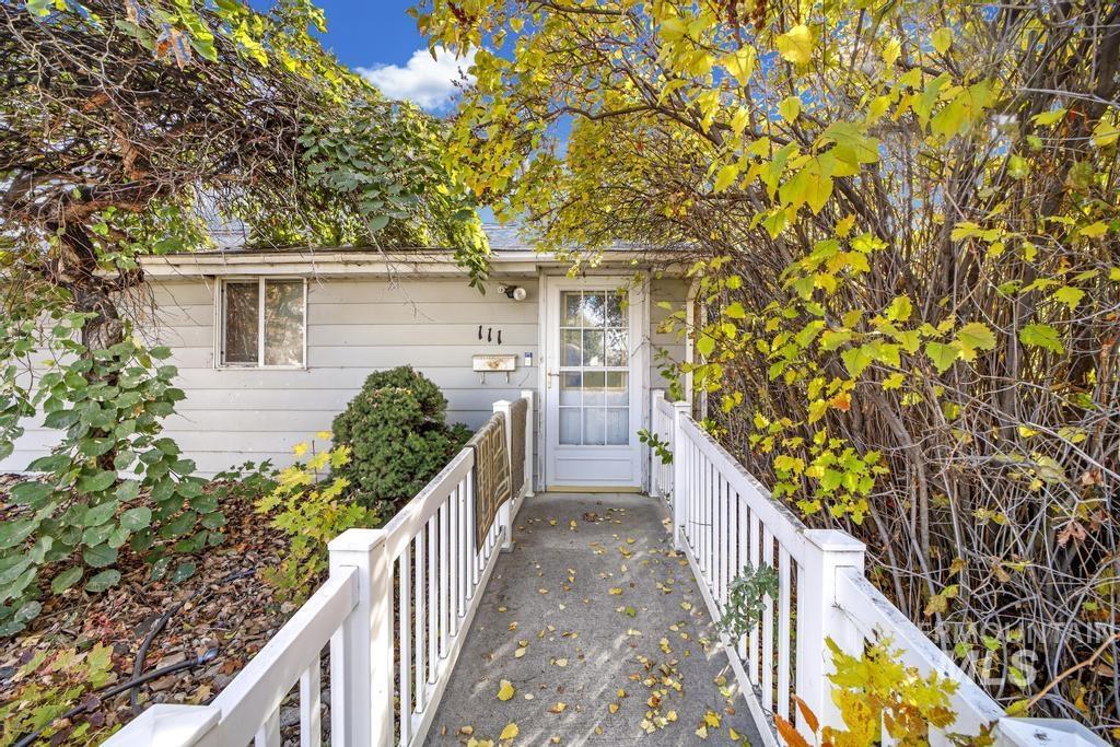 111 2nd Street Rupert, ID 83350 - Photo 1 of 45 Inviting front entry featuring a white paneled door with glass inserts, a dedicated concrete walkway, and white picket railings