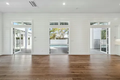 a view of a room with wooden floor and windows