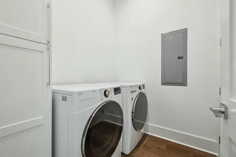 an aerial view of residential houses with outdoor space and trees