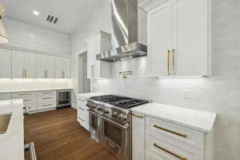 a view of a kitchen with wooden floor and windows