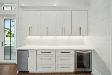 a view of wooden floor and windows in a room