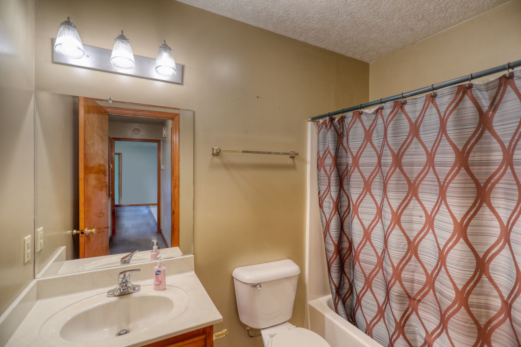 3845 Armstrong Road Springfield, TN 37172 - Photo 18 of 34 a bathroom with a toilet a sink and mirror