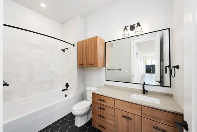 a bathroom with a sink a toilet and a bathtub