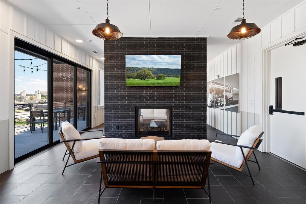 4510 Terry-O Lane, Unit 416 Austin, TX 78745 - Photo 28 of 40 a living room with furniture a chandelier and a fireplace