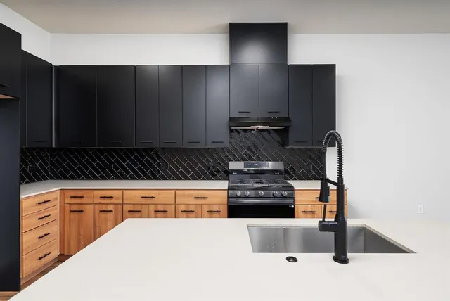 a kitchen with granite countertop a stove and a refrigerator