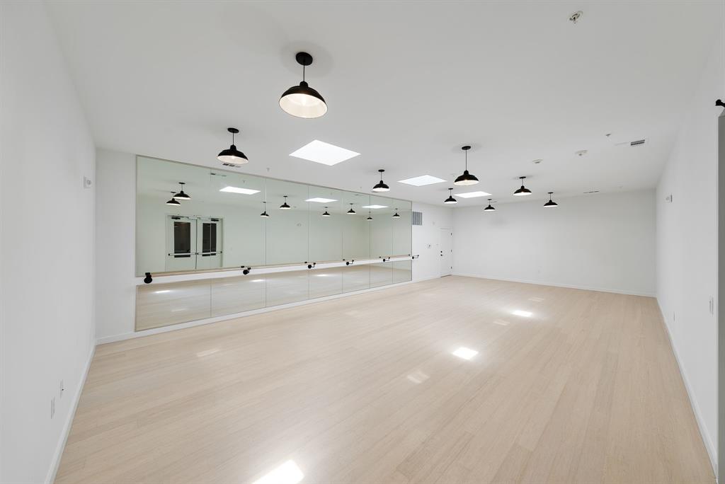 4510 Terry-O Lane, Unit 416 Austin, TX 78745 - Photo 31 of 40 an empty room with a chandelier fan and wooden floor