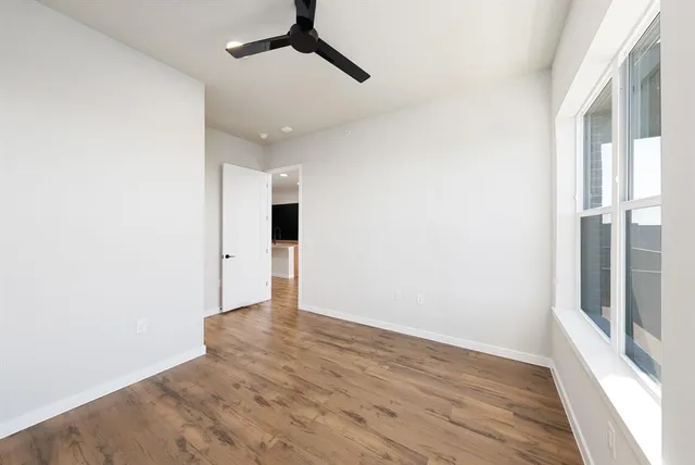 a view of an empty room with wooden floor