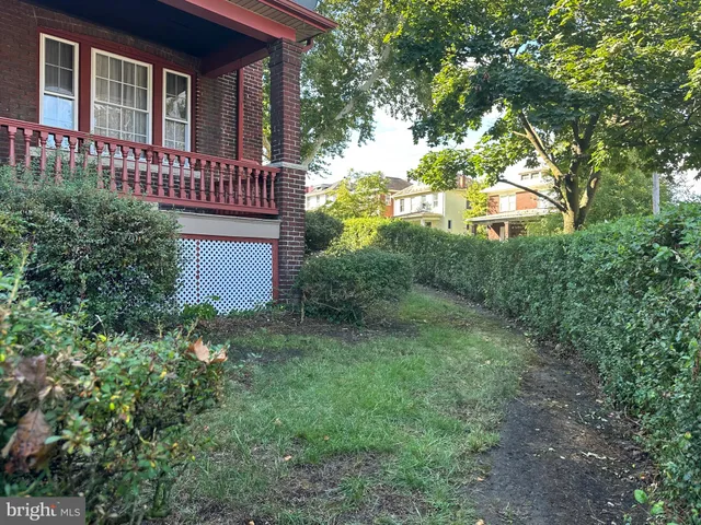 a view of a house with a yard and tree s