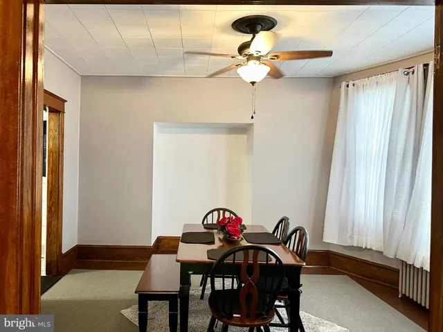 a view of a dining room with furniture and window