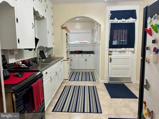 a kitchen with stainless steel appliances granite countertop a refrigerator and a stove