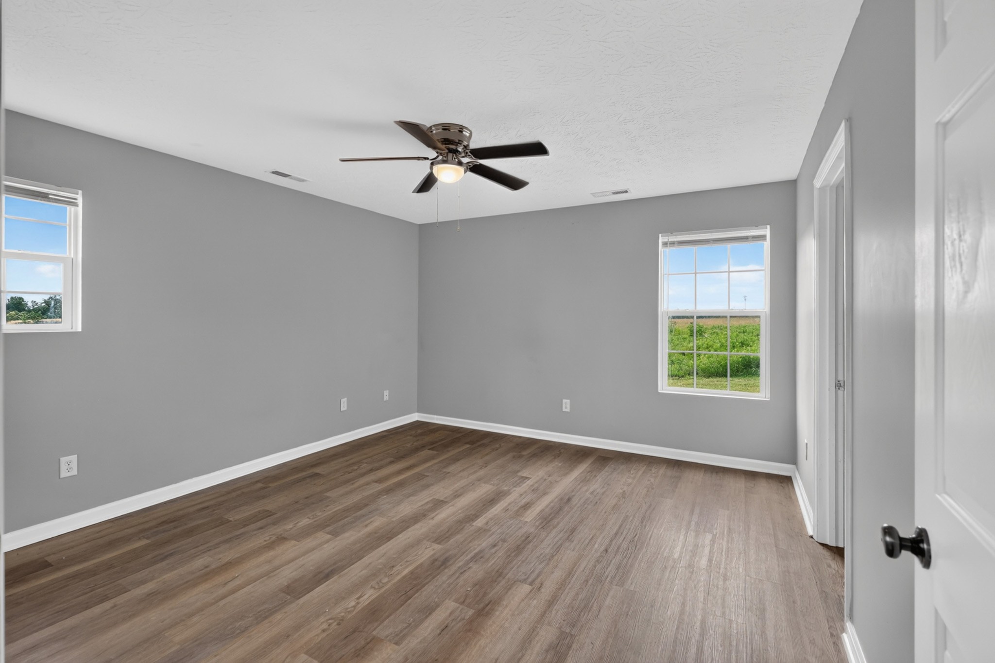120 Driver Road Lafayette, TN 37083 - Photo 14 of 39 a view of empty room with wooden floor and fan