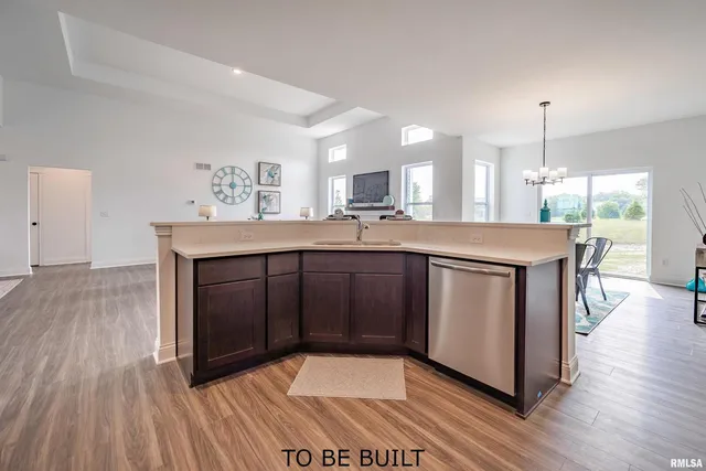 a kitchen with stainless steel appliances granite countertop a stove a sink and a wooden floors