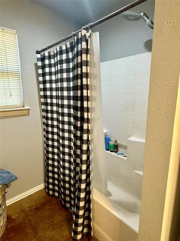 a bathroom with a shower and a sink