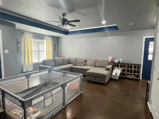 a living room with furniture and a chandelier