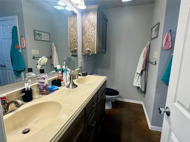 a bathroom with a tub sink and mirror