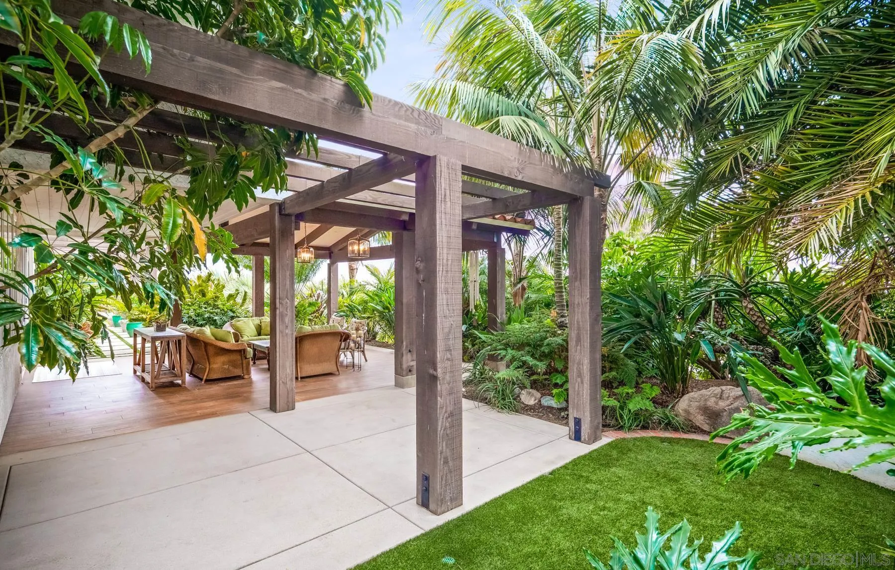 4665 Sunburst Road Carlsbad, CA 92008 - Photo 16 of 29 a view of a patio with a table and chairs next to a yard
