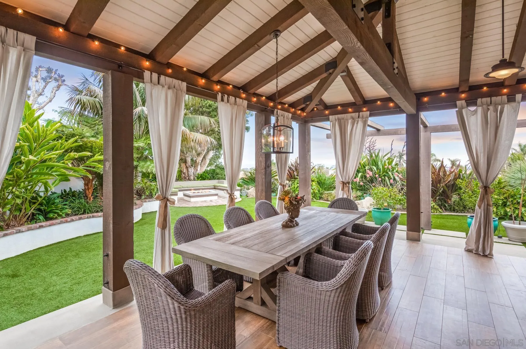4665 Sunburst Road Carlsbad, CA 92008 - Photo 17 of 29 a view of a patio with a table chairs and a backyard