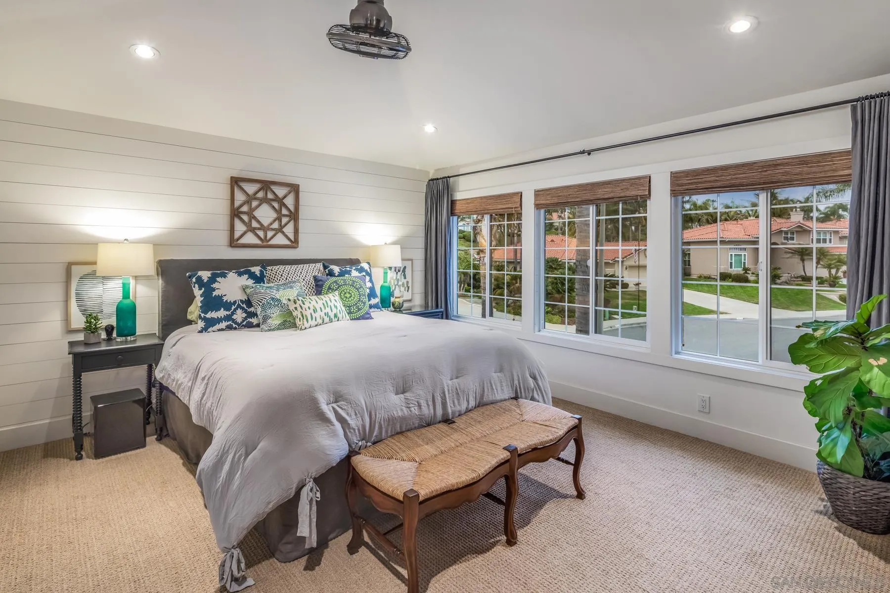 4665 Sunburst Road Carlsbad, CA 92008 - Photo 18 of 29 a bedroom with a large bed and a potted plant
