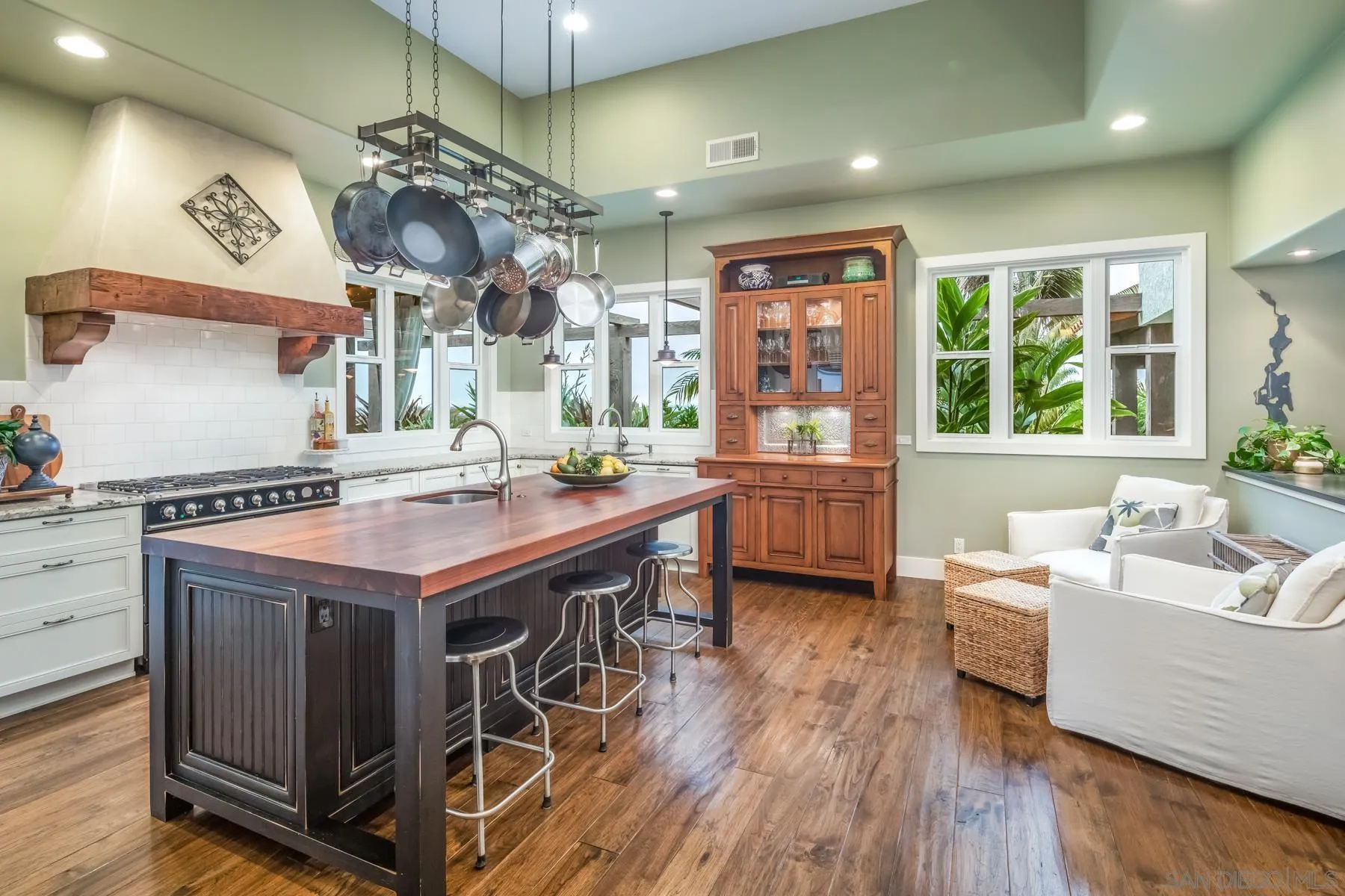4665 Sunburst Road Carlsbad, CA 92008 - Photo 9 of 29 a kitchen with stainless steel appliances granite countertop a sink a stove and a wooden floors