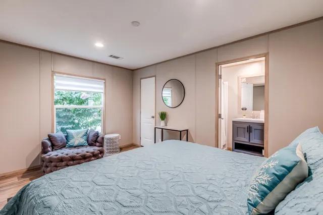 a bedroom with a large bed and a window