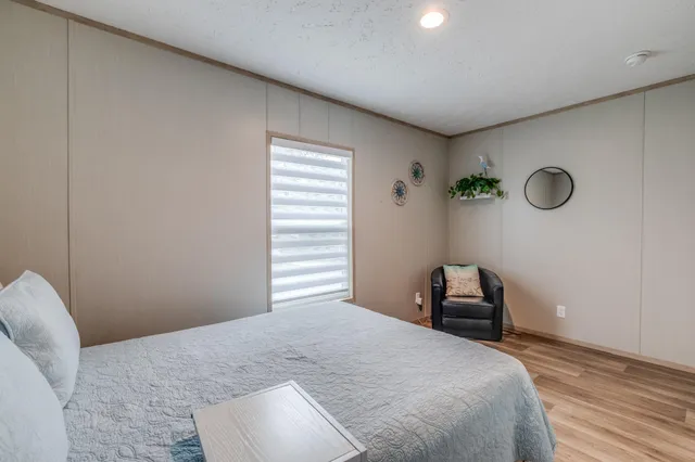 a bedroom with a bed and a window