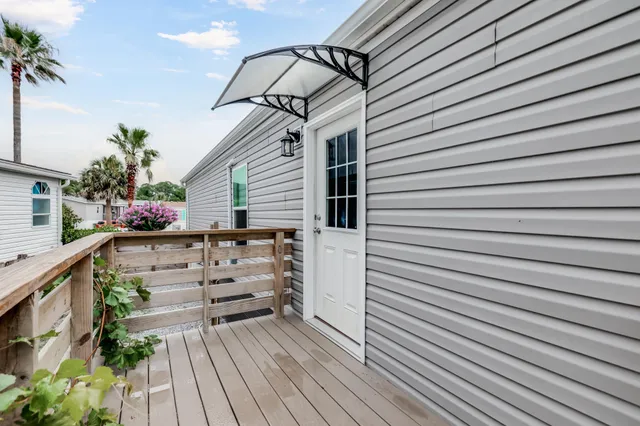 a view of a house with wooden deck