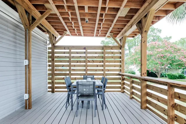 a view of a balcony with chairs and wooden floor